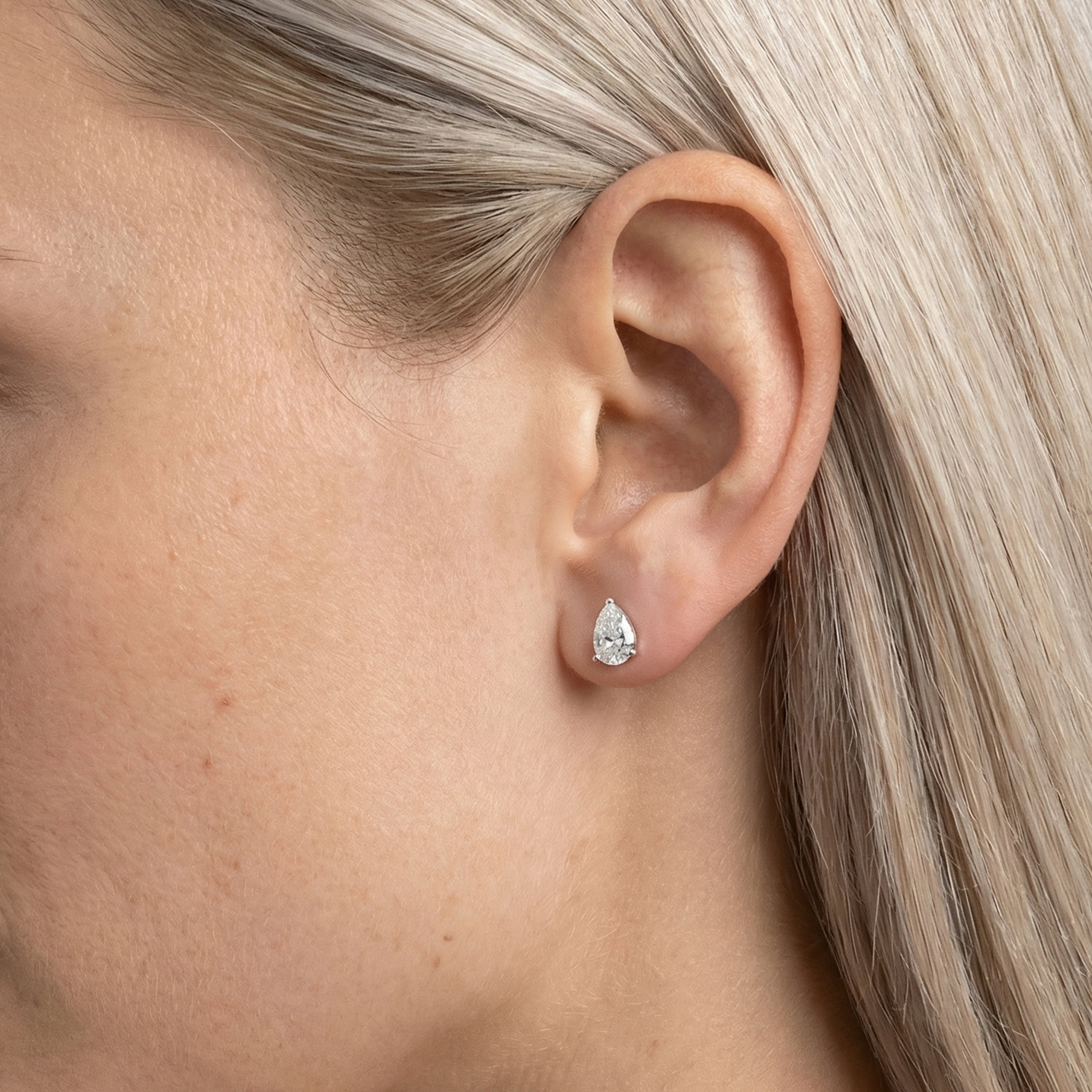 1.25 carat pear lab grown diamond stud earring in 14k white gold on ear by Michael Gabriels
