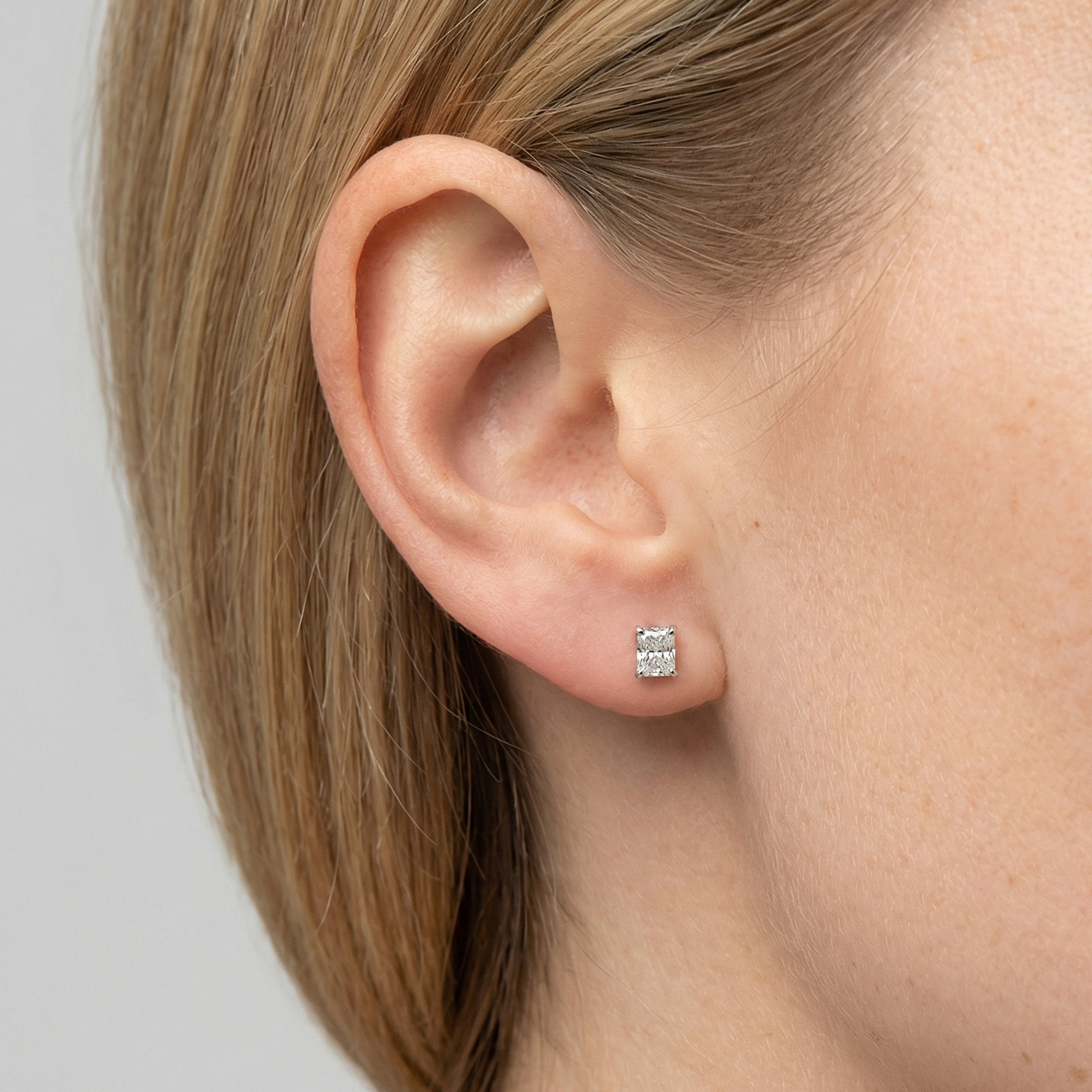 1.25 carat radiant lab grown diamond stud earring in 14k white gold on ear by Michael Gabriels
