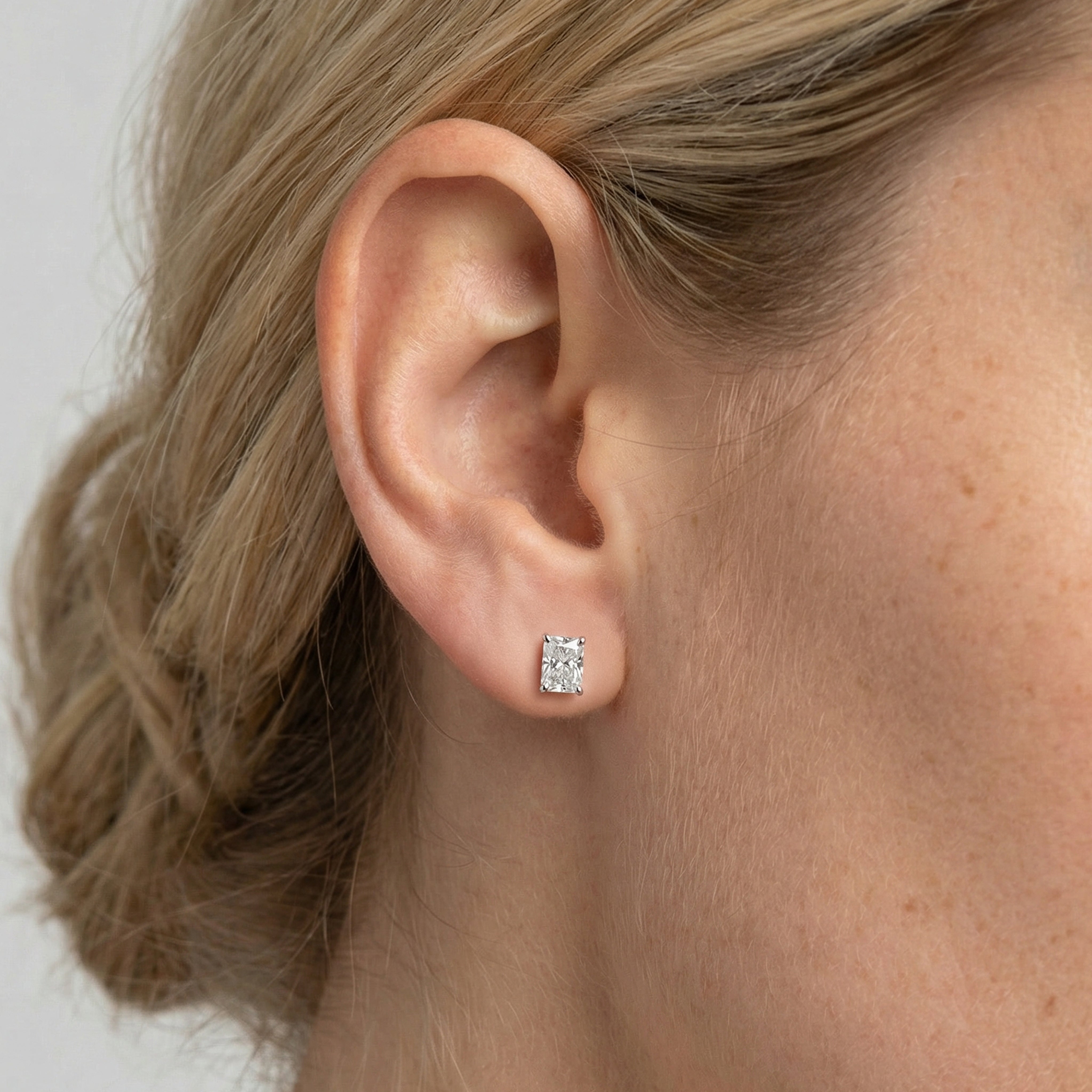 1.5 carat radiant lab grown diamond stud earring in 14k white gold on ear by Michael Gabriels