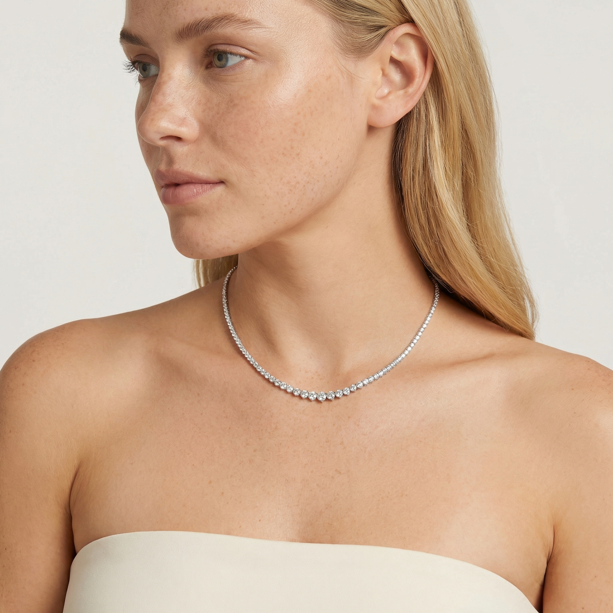 10 carat lab grown diamond graduated tennis necklace in 14k white gold on neck by Michael Gabriels