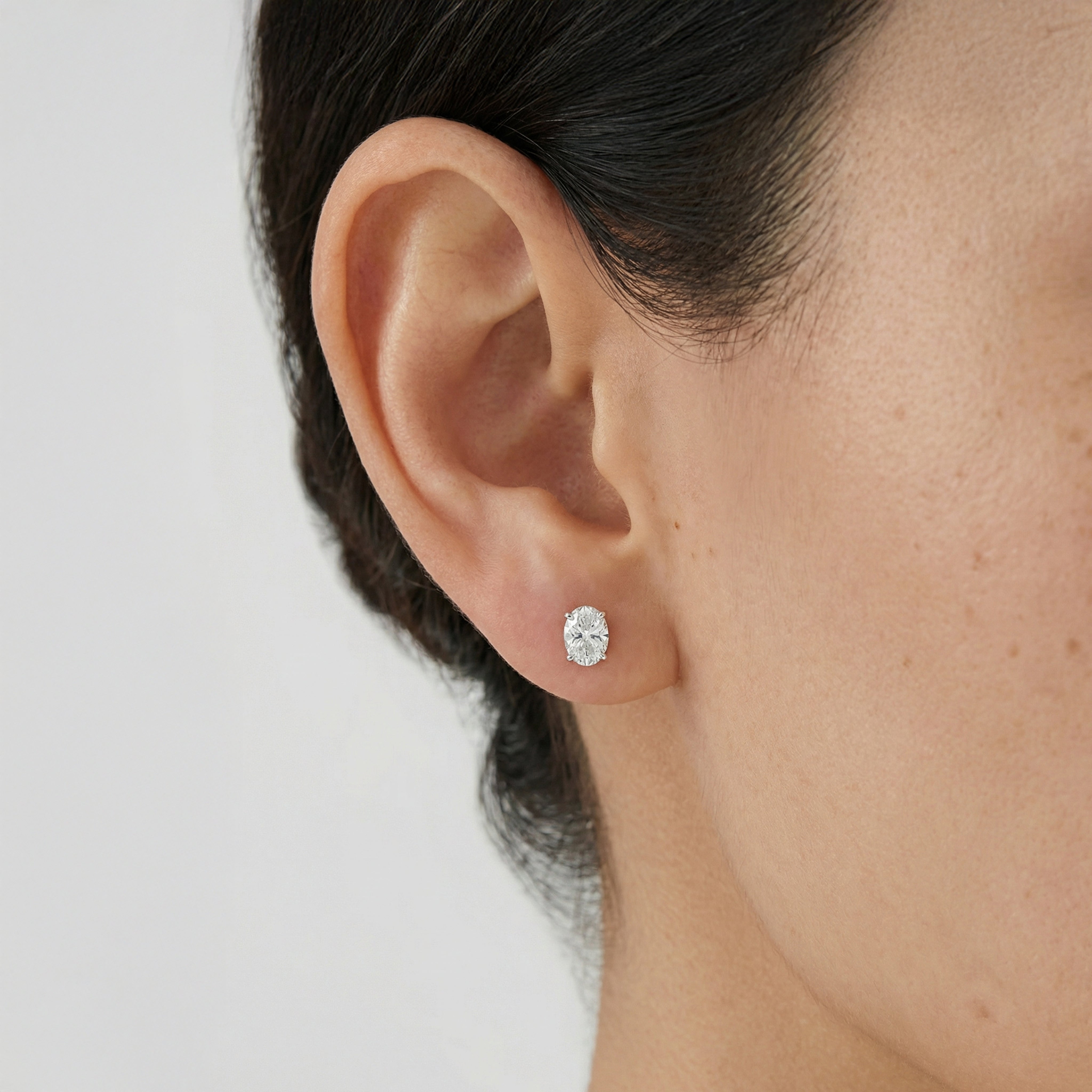 1 carat oval lab grown diamond stud earring in 14k white gold on ear by Michael Gabriels