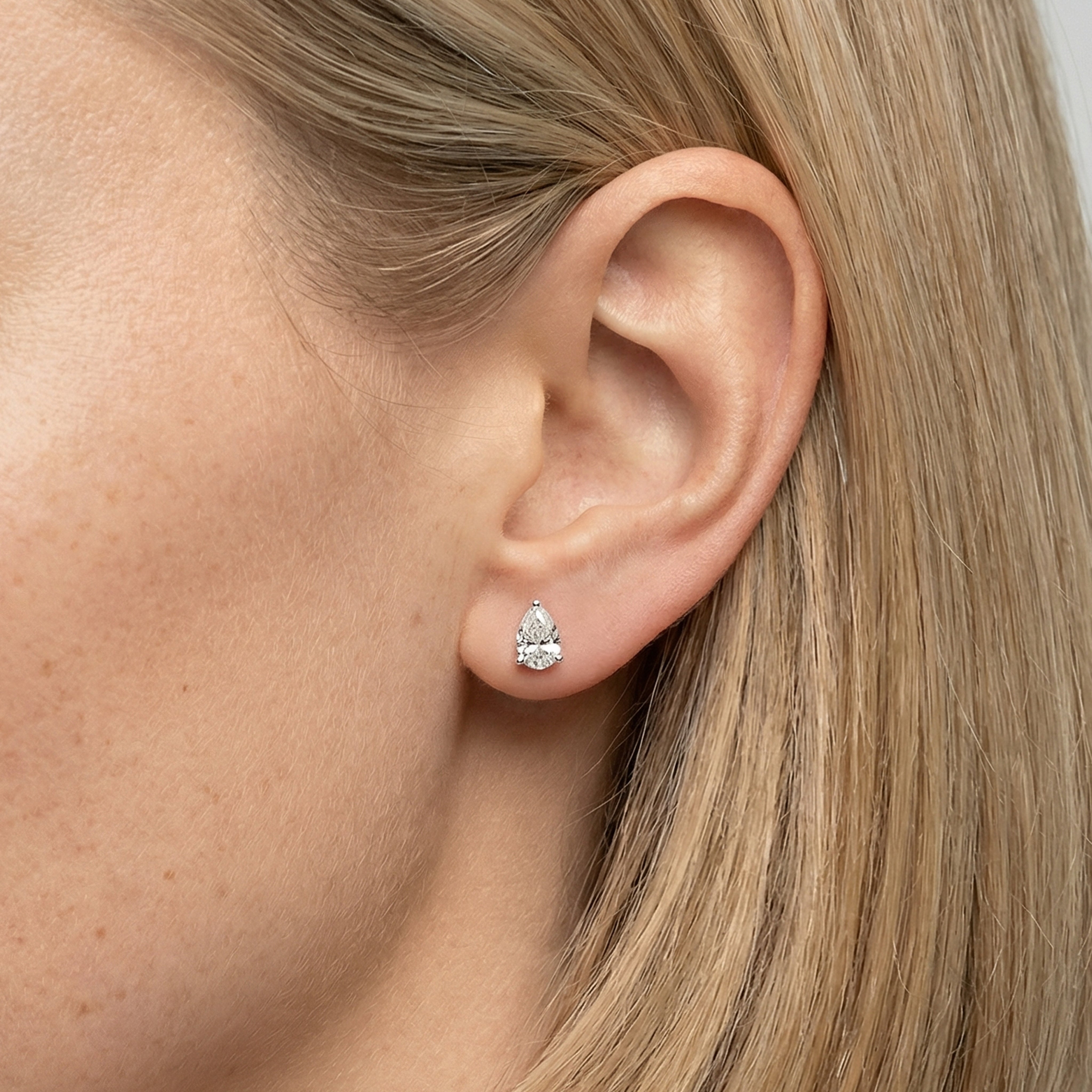 1 carat pear lab grown diamond stud earring in 14k white gold on ear by Michael Gabriels