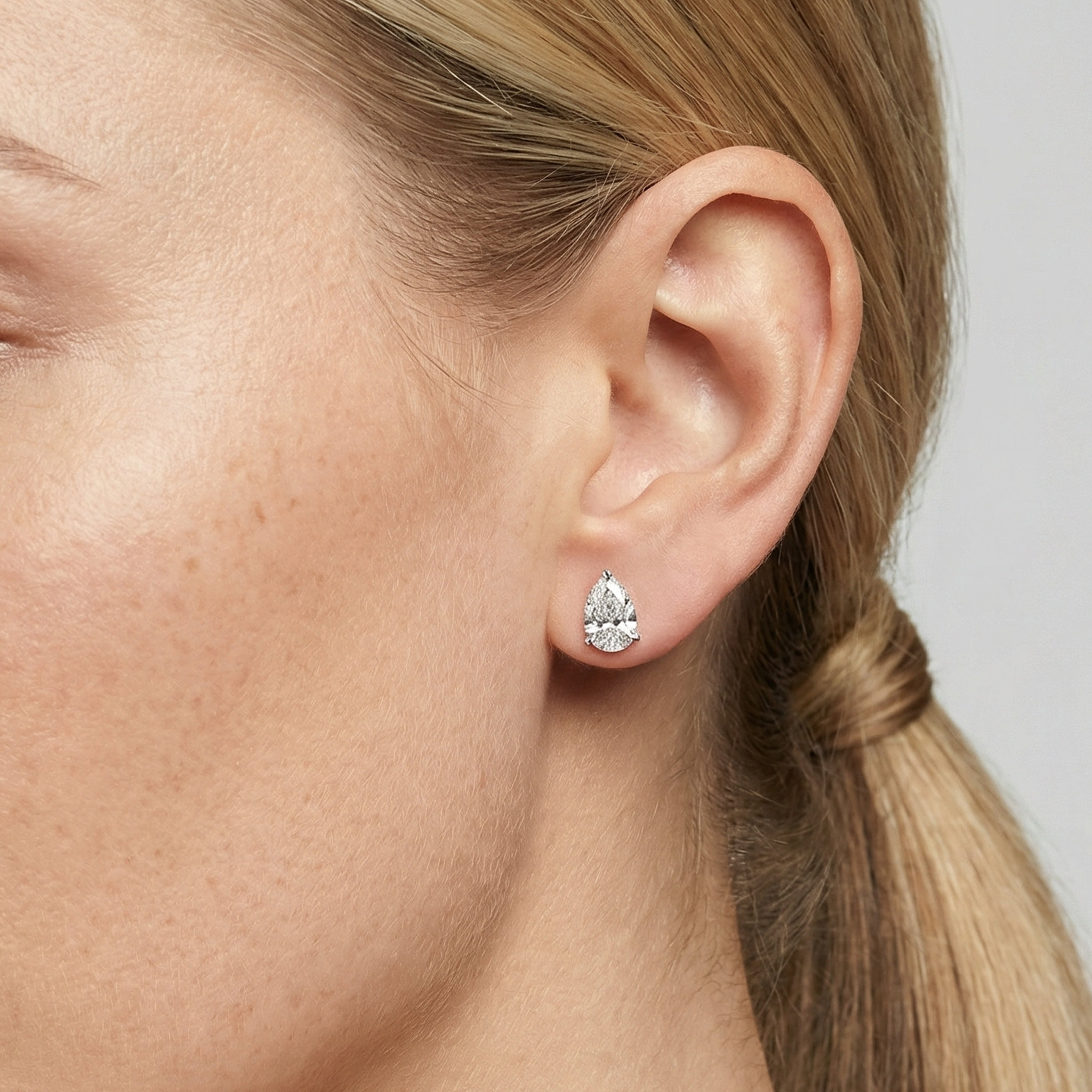 2 carat pear lab grown diamond stud earring in 14k white gold on ear by Michael Gabriels