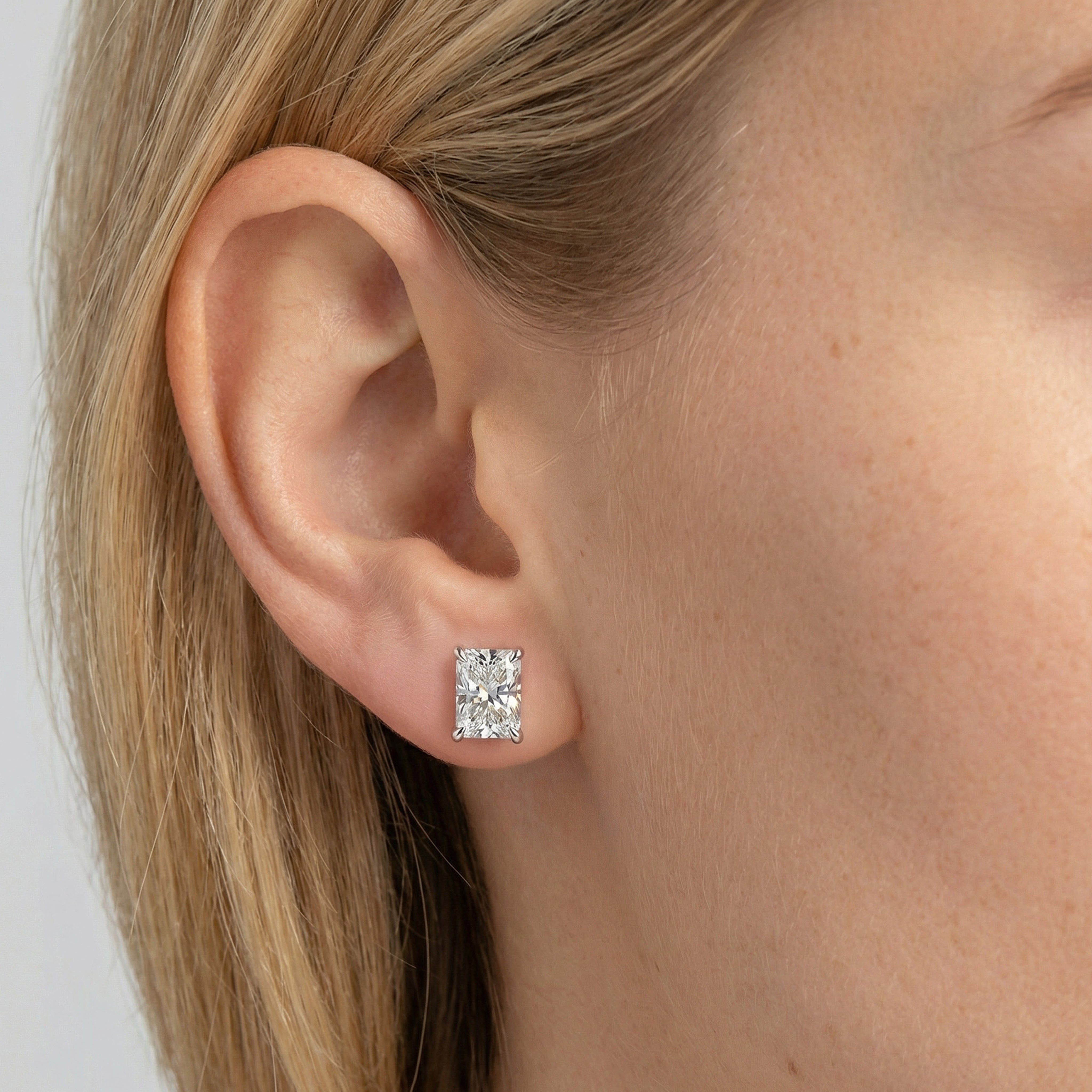 4 carat radiant lab grown diamond stud earring in 14k white gold on ear by Michael Gabriels