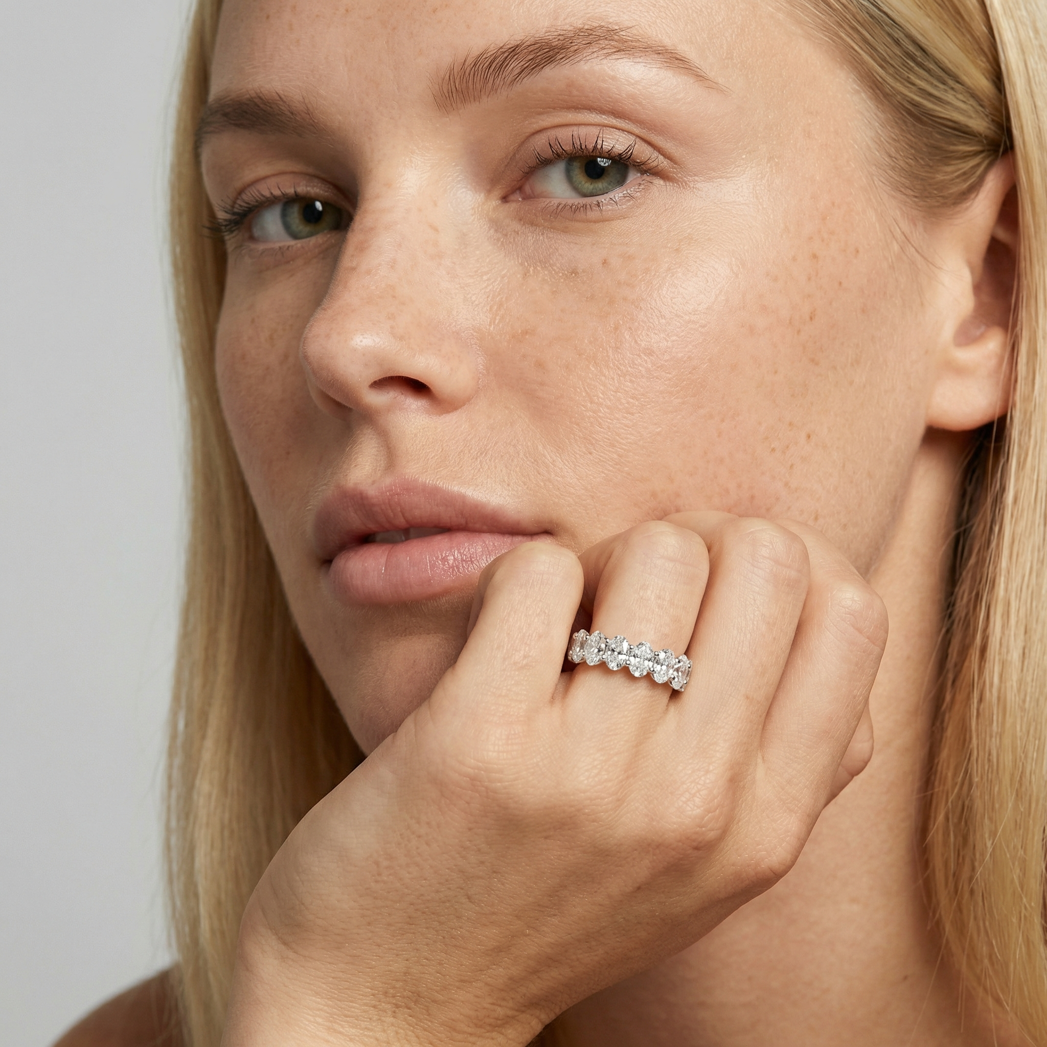 5 carat oval lab grown diamond basket eternity band in 14k white gold on finger by Michael Gabriels