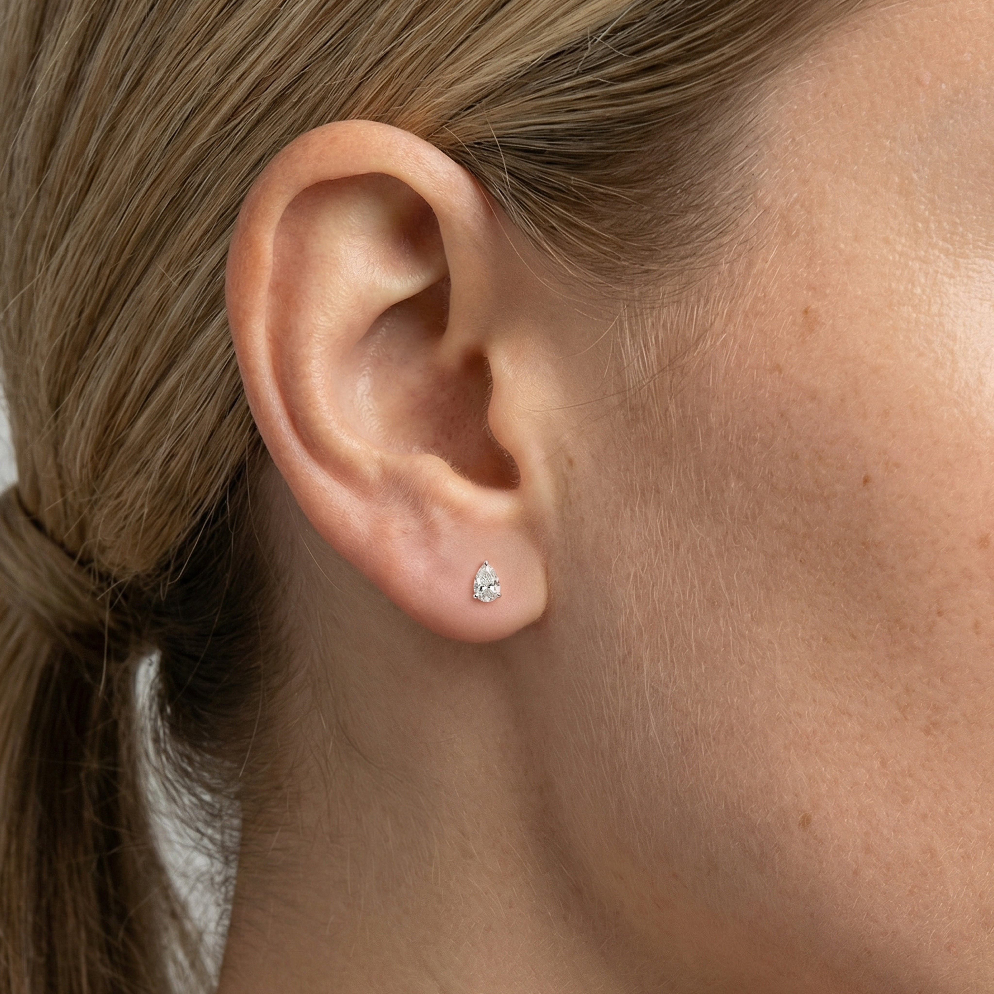 .5 carat pear lab grown diamond stud earring in 14k white gold on ear by Michael Gabriels