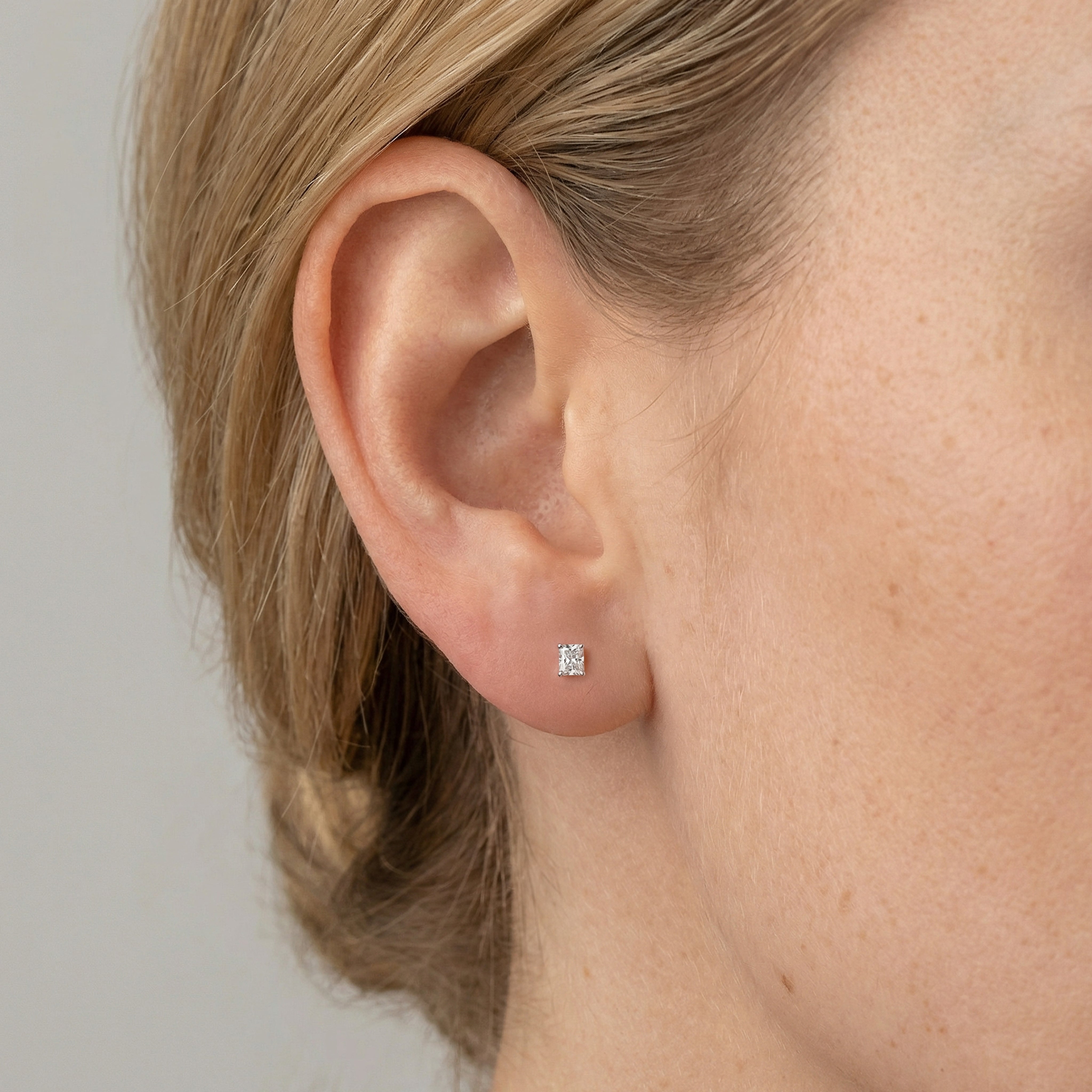 .5 carat radiant lab grown diamond stud earring in 14k white gold on ear by Michael Gabriels