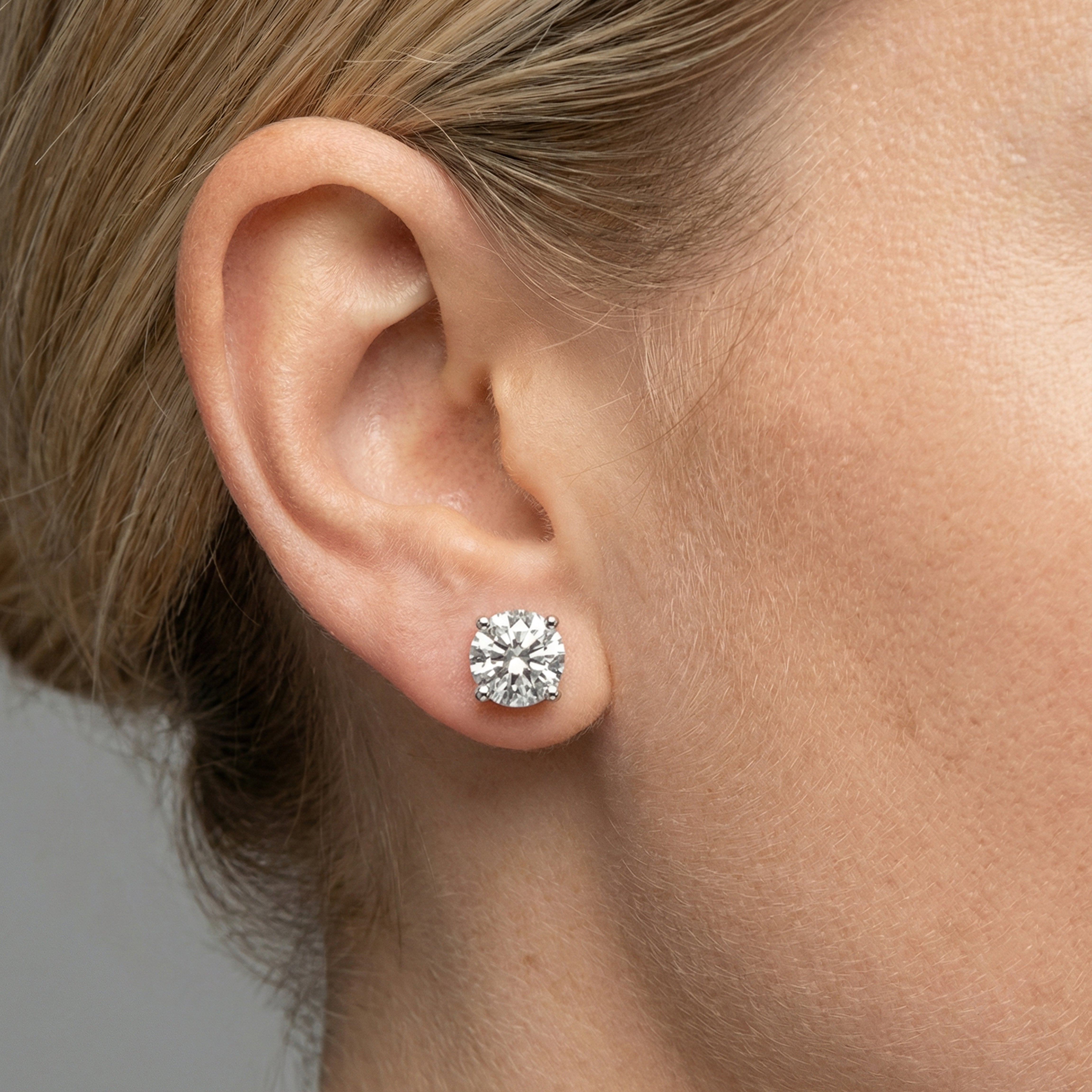 5 carat round lab grown diamond stud earring in 14k white gold on ear by Michael Gabriels