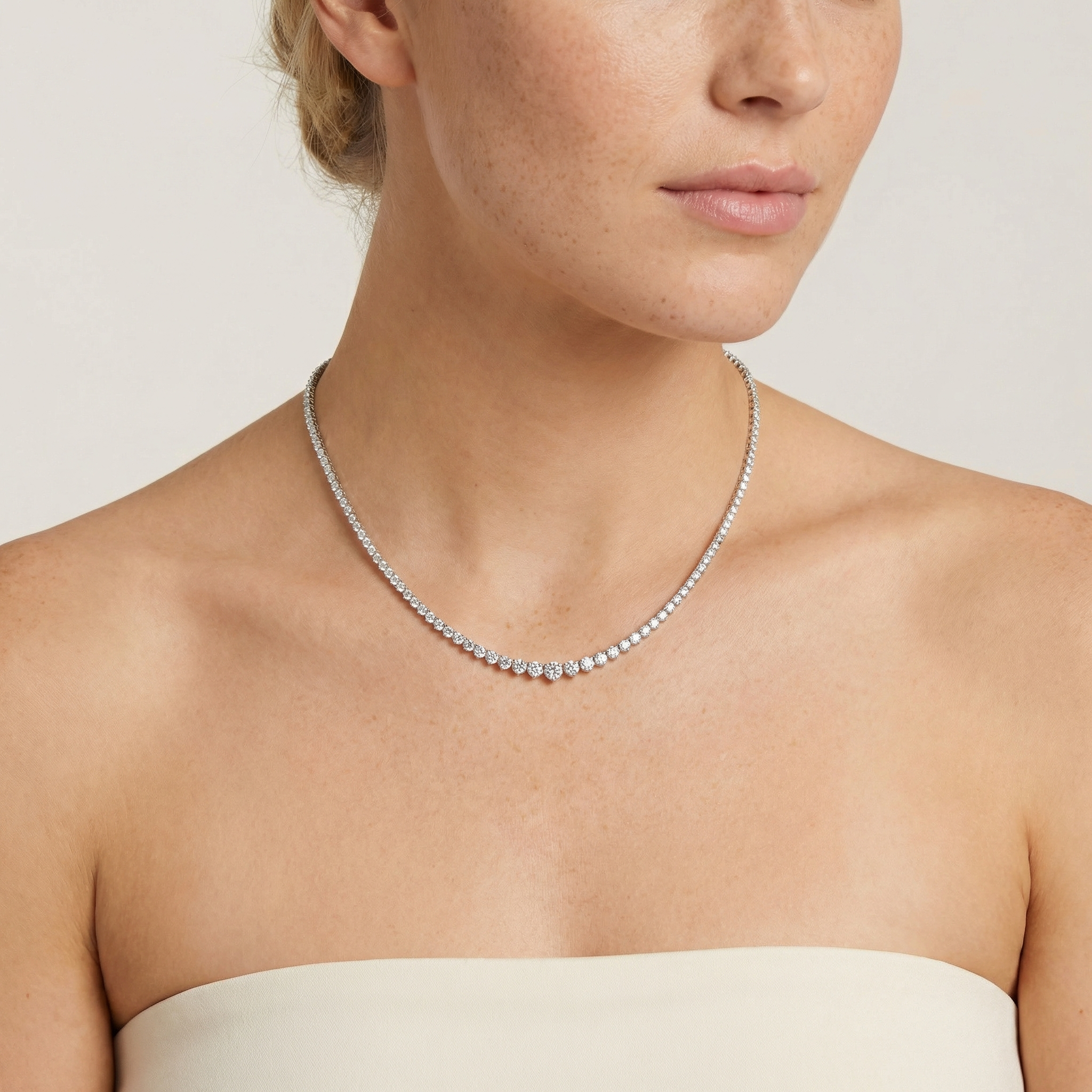 7 1/2 carat lab grown diamond graduated tennis necklace in 14k white gold on neck by Michael Gabriels