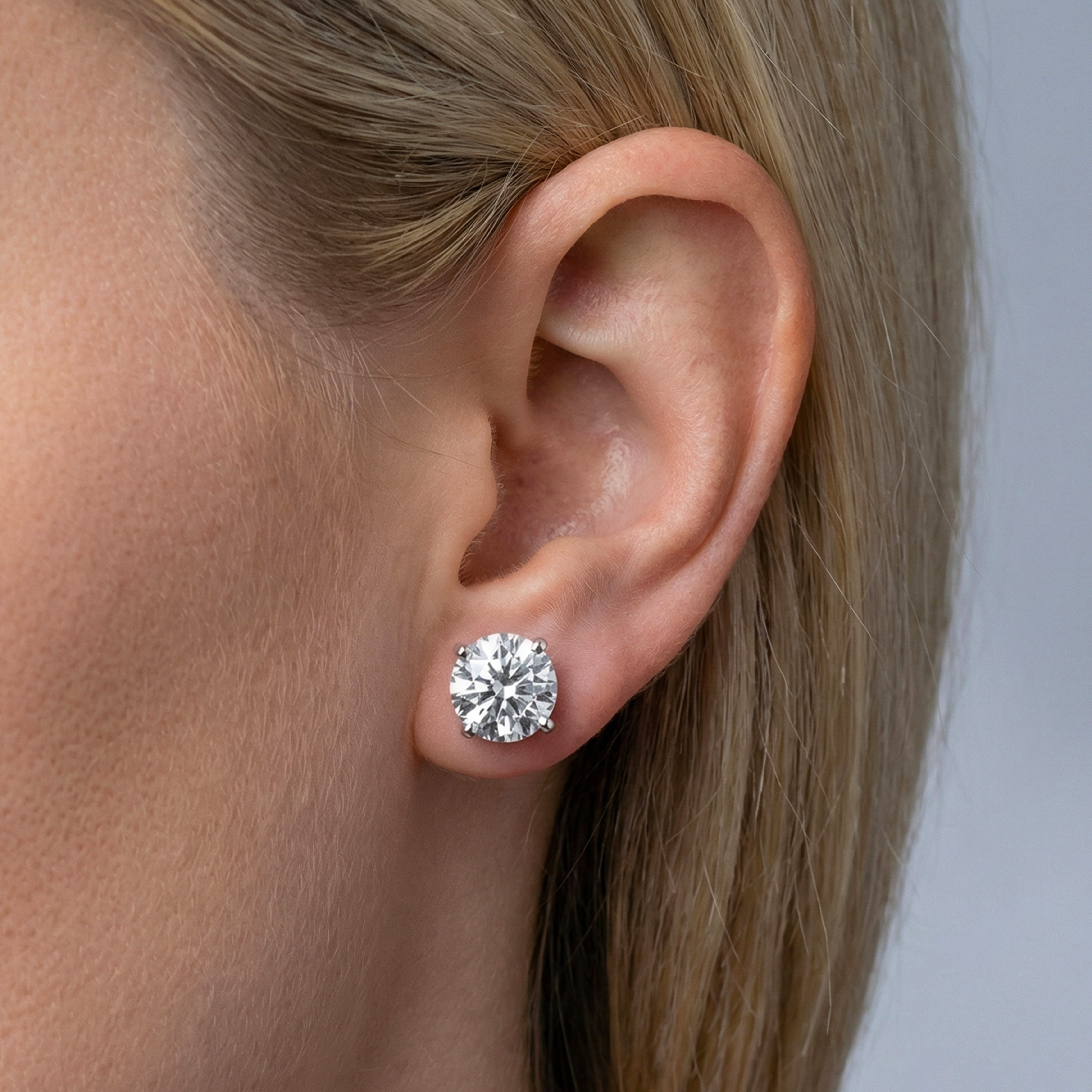 8 carat round lab grown diamond stud earring in 14k white gold on ear by Michael Gabriels