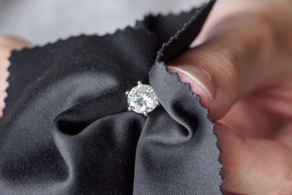 Jeweler cleans a lab diamond engagement ring