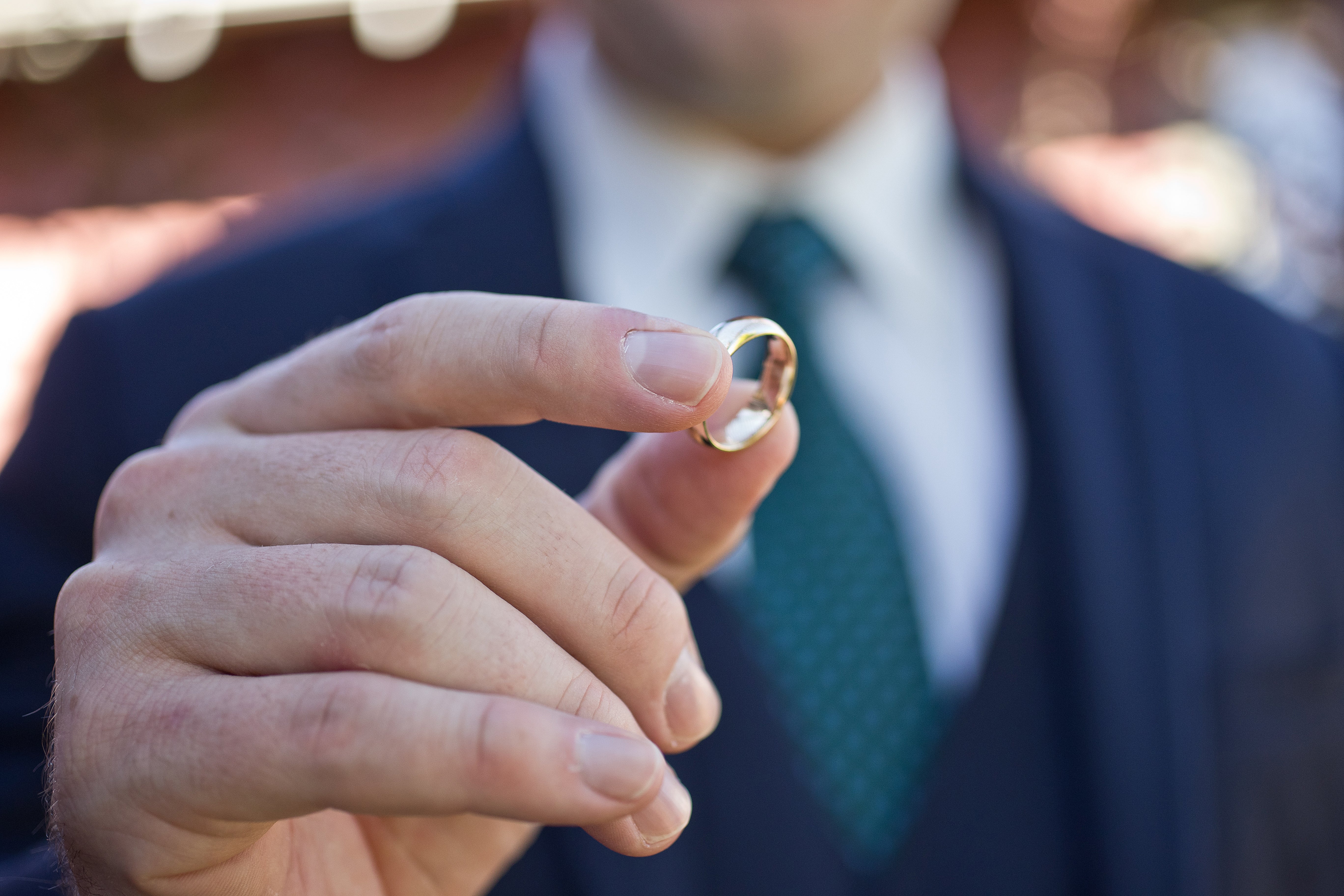 Man holding gold wedding band