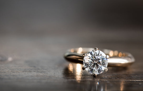 Diamond ring resting on a table 