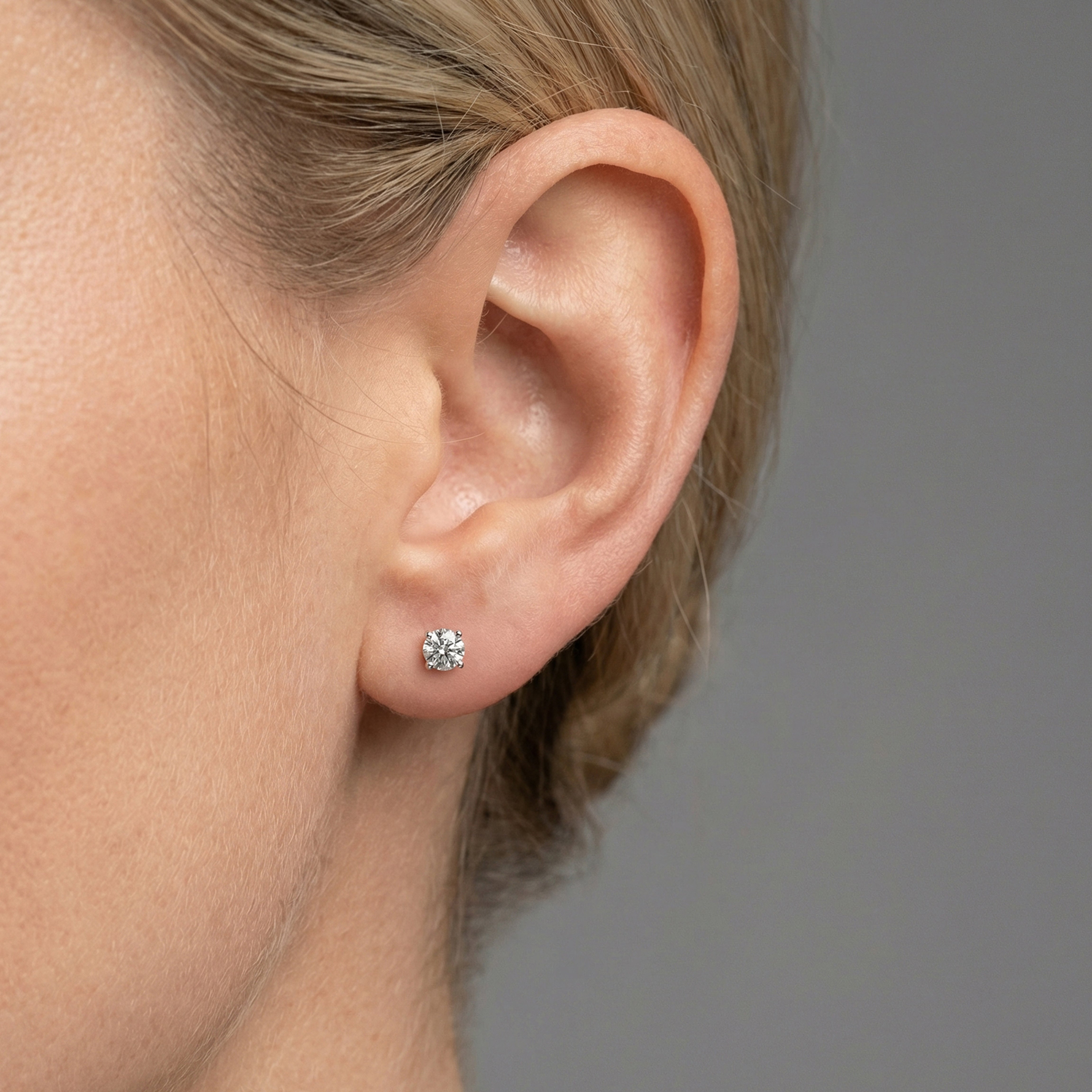 1.25 carat round lab grown diamond stud earring in 14k white gold on ear by Michael Gabriels