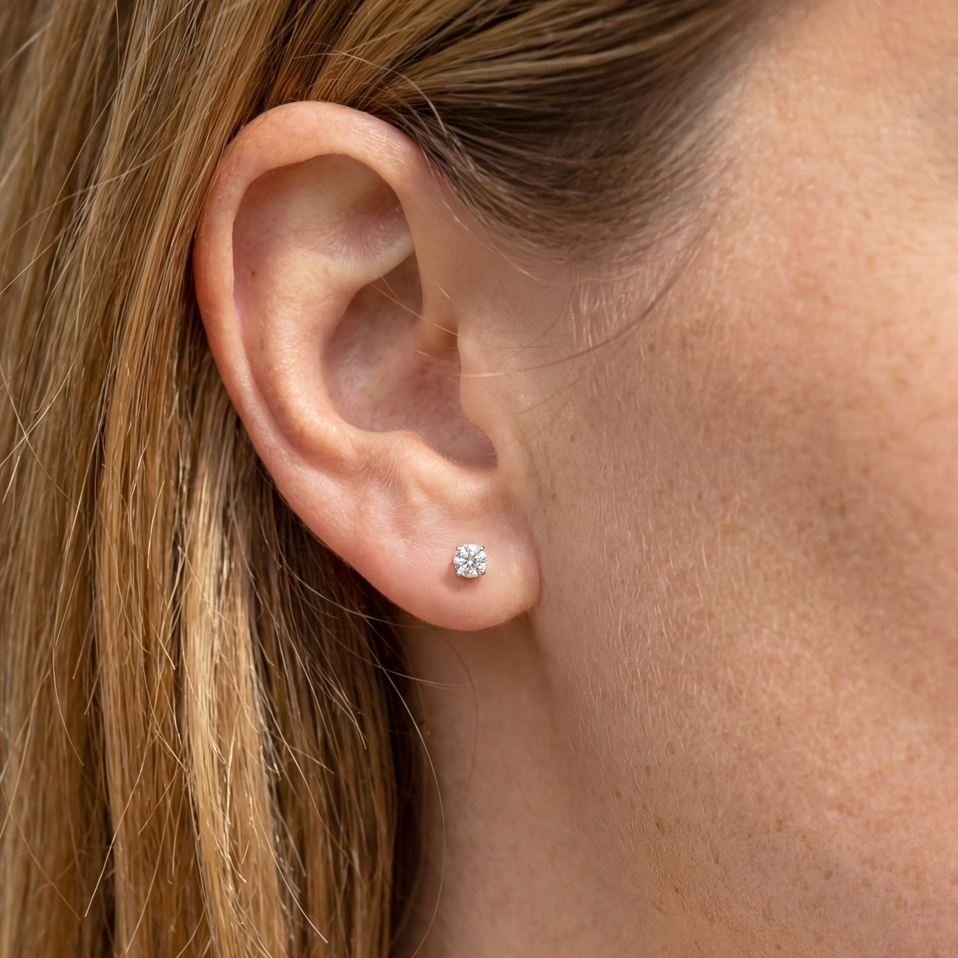 1 carat round lab grown diamond stud earring in 14k white gold on ear by Michael Gabriels