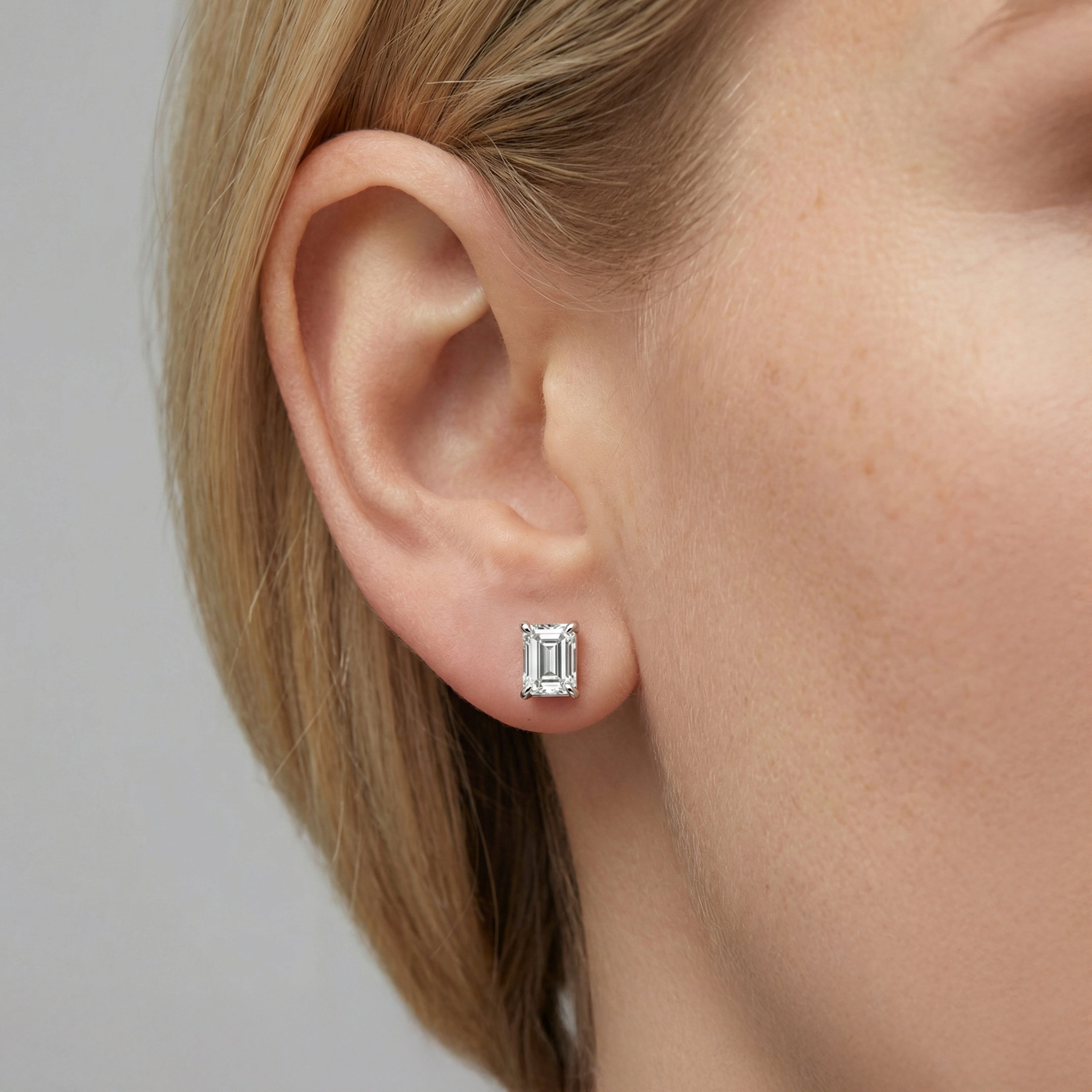 2 carat emerald lab grown diamond stud earring in 14k white gold on ear by Michael Gabriels