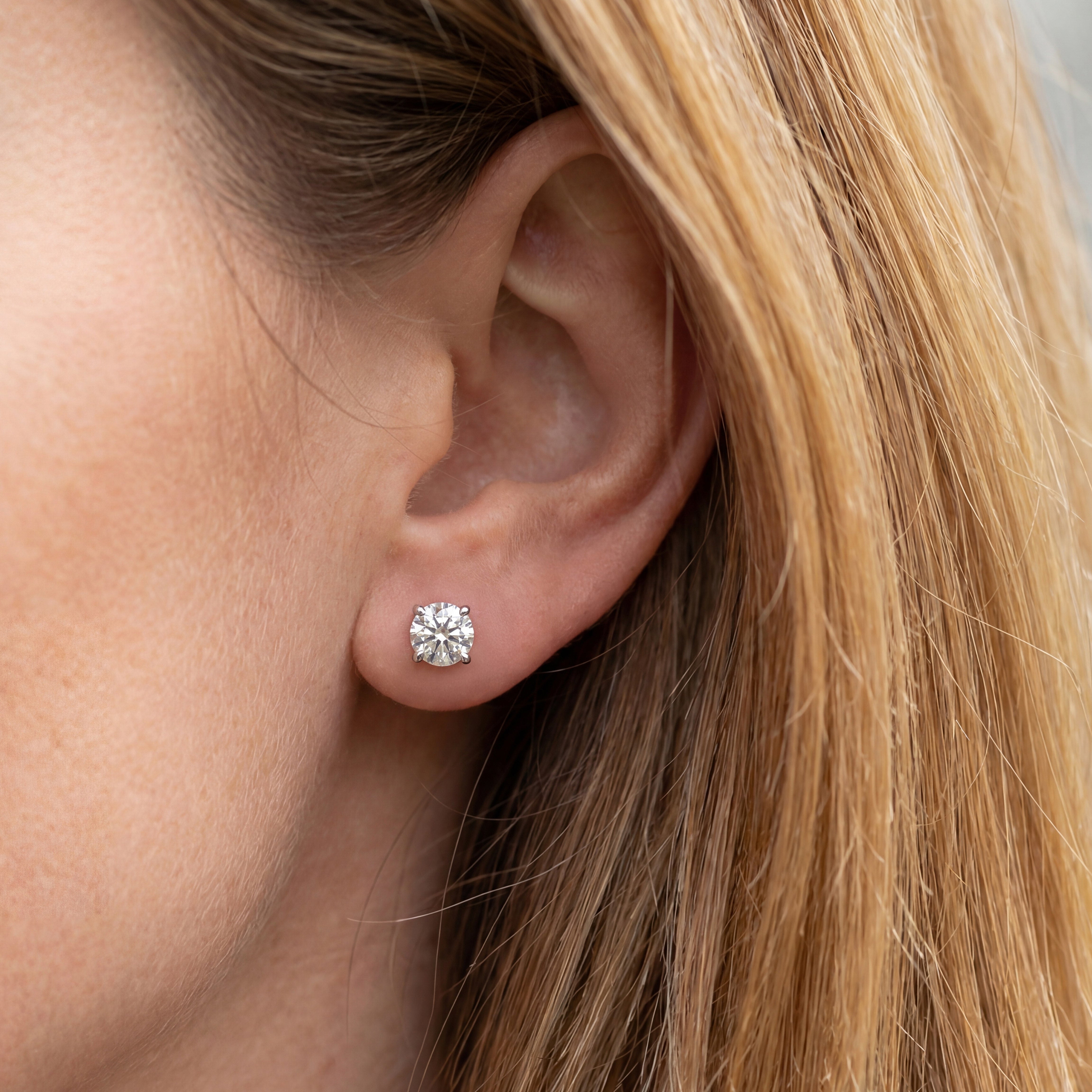 2 carat round lab grown diamond stud earring in 14k white gold on ear by Michael Gabriels