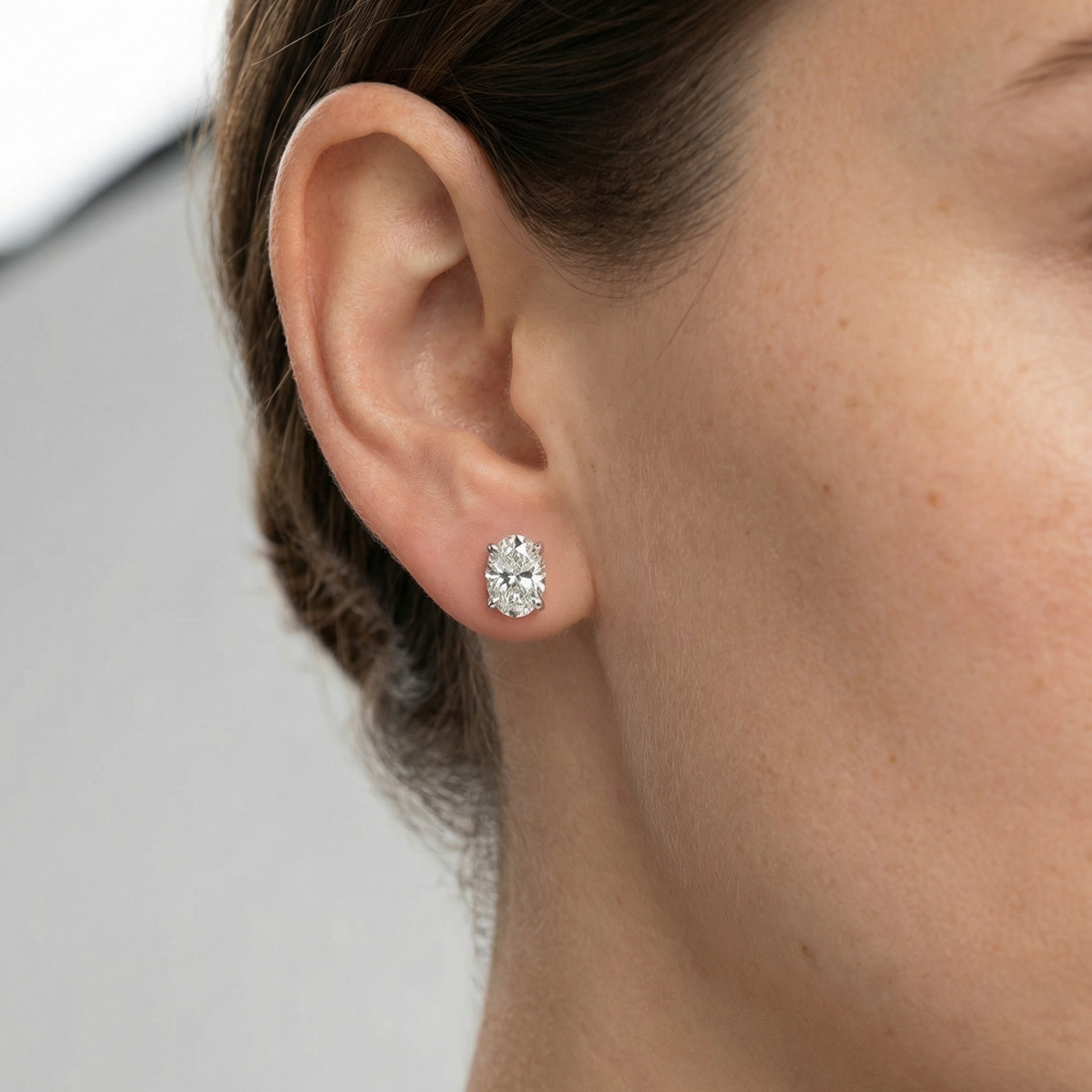 3 carat oval lab grown diamond stud earring in 14k white gold on ear by Michael Gabriels