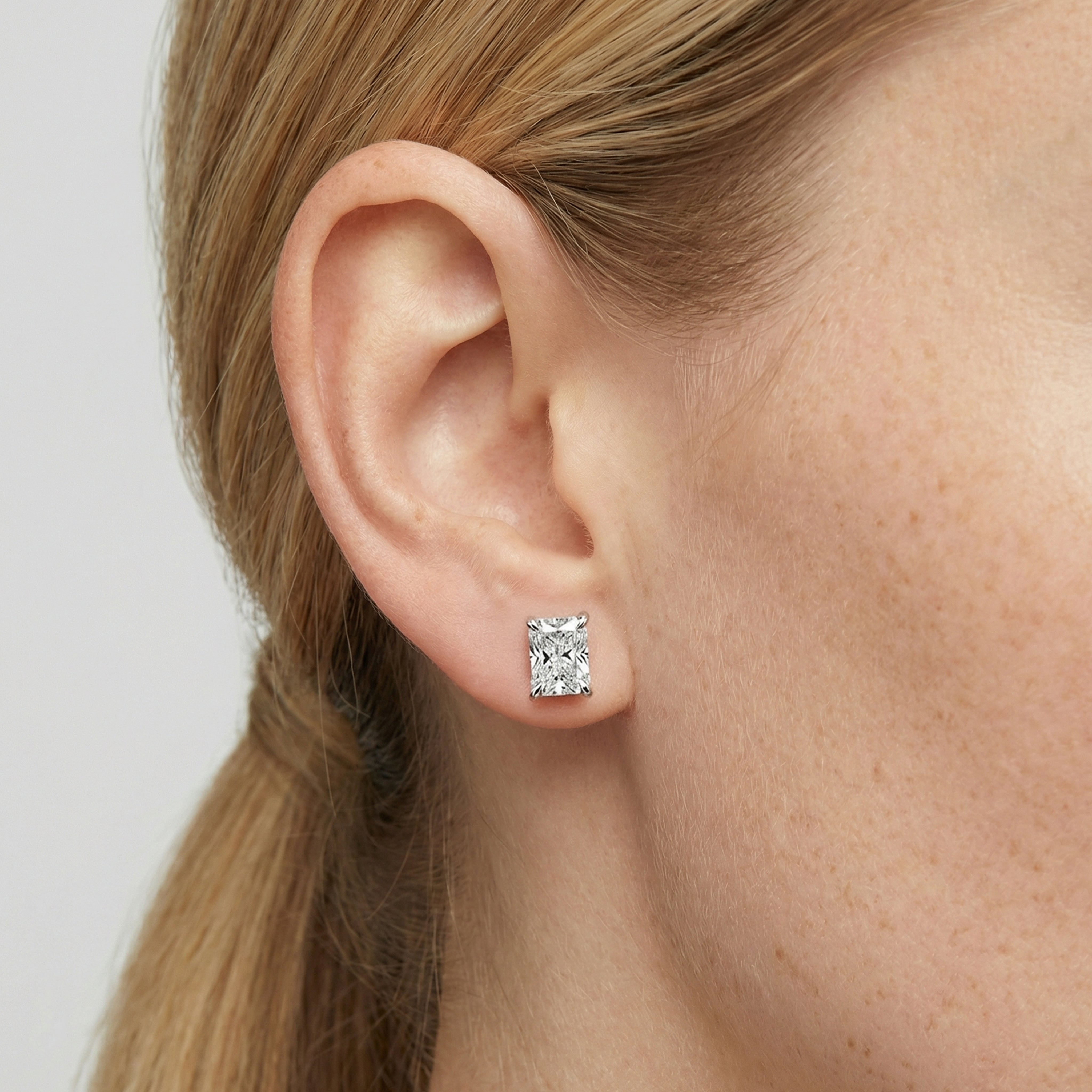 3 carat radiant lab grown diamond stud earring in 14k white gold on ear by Michael Gabriels