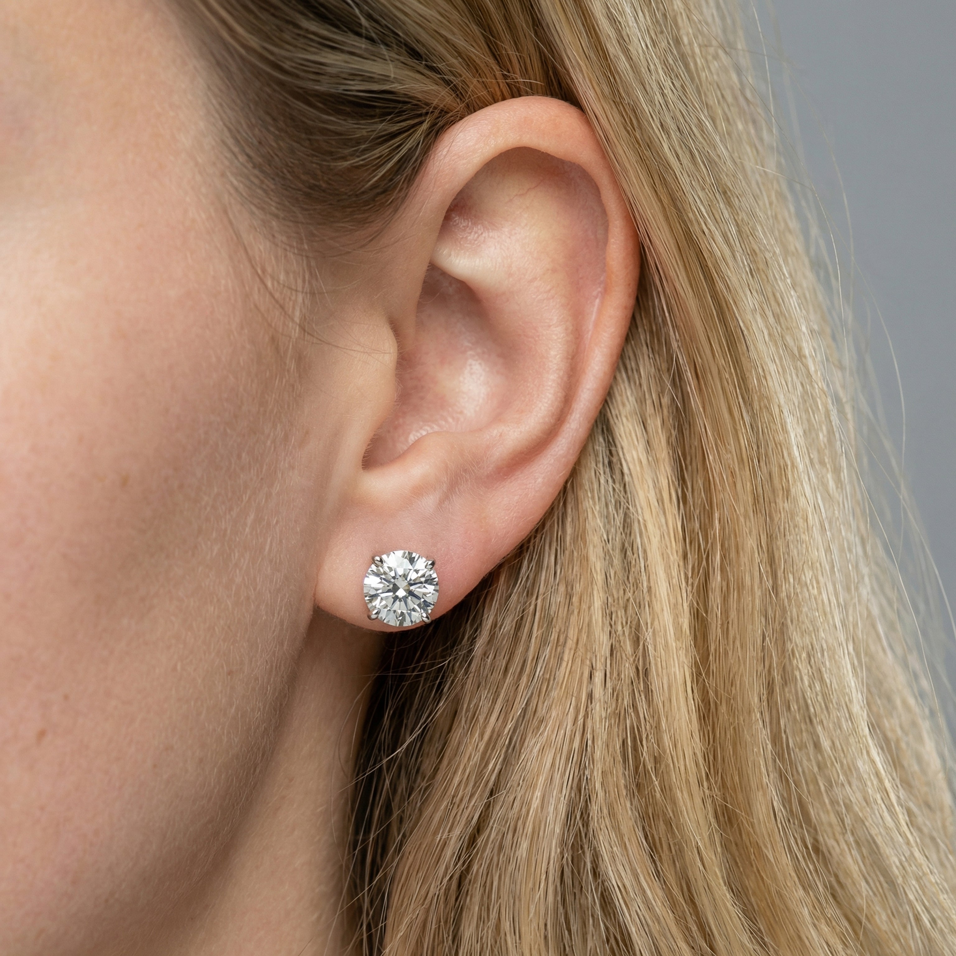 3 carat round lab grown diamond stud earring in 14k white gold on ear by Michael Gabriels