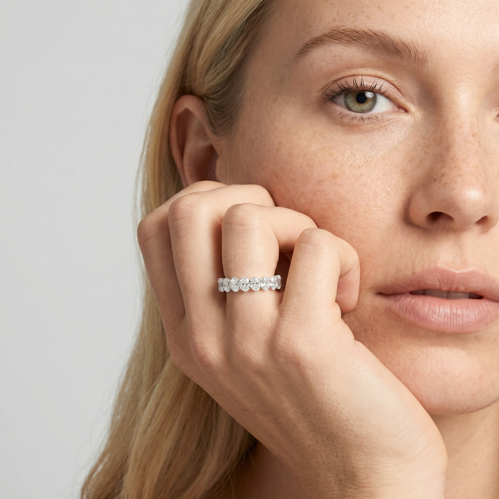 4 carat oval lab grown diamond basket eternity band in 14k white gold on finger by Michael Gabriels