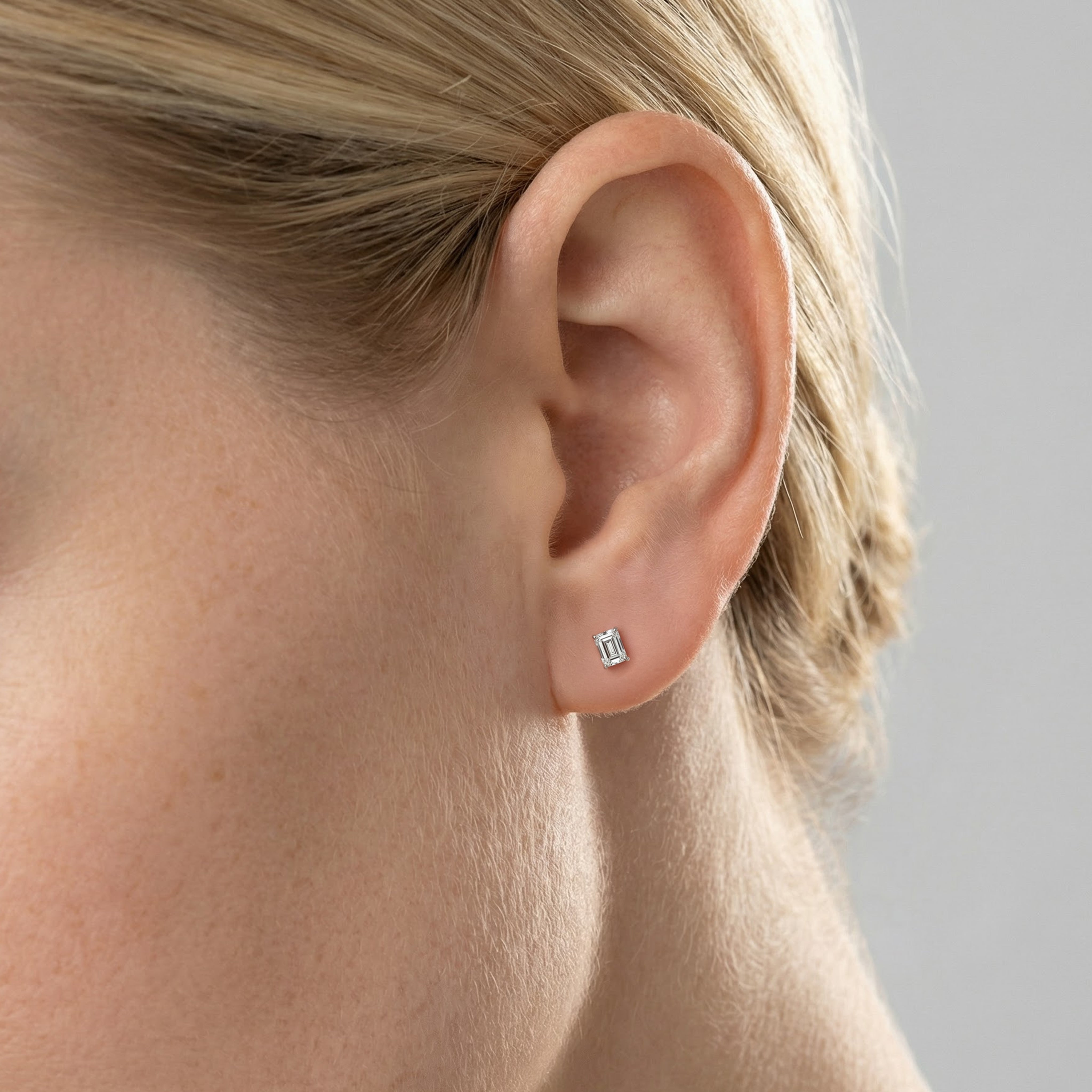 .5 carat emerald lab grown diamond stud earring in 14k white gold on ear by Michael Gabriels