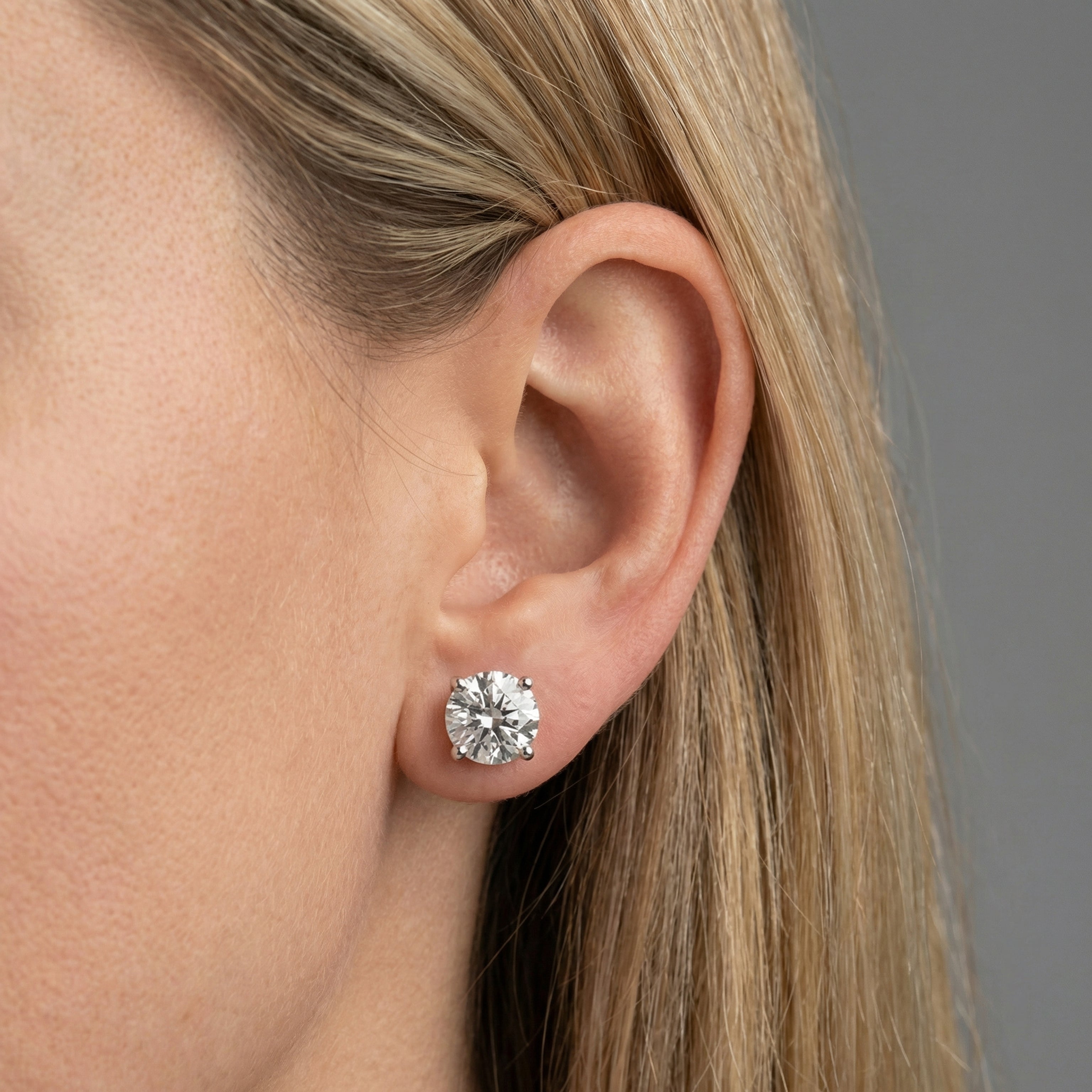 6 carat round lab grown diamond stud earring in 14k white gold on ear by Michael Gabriels