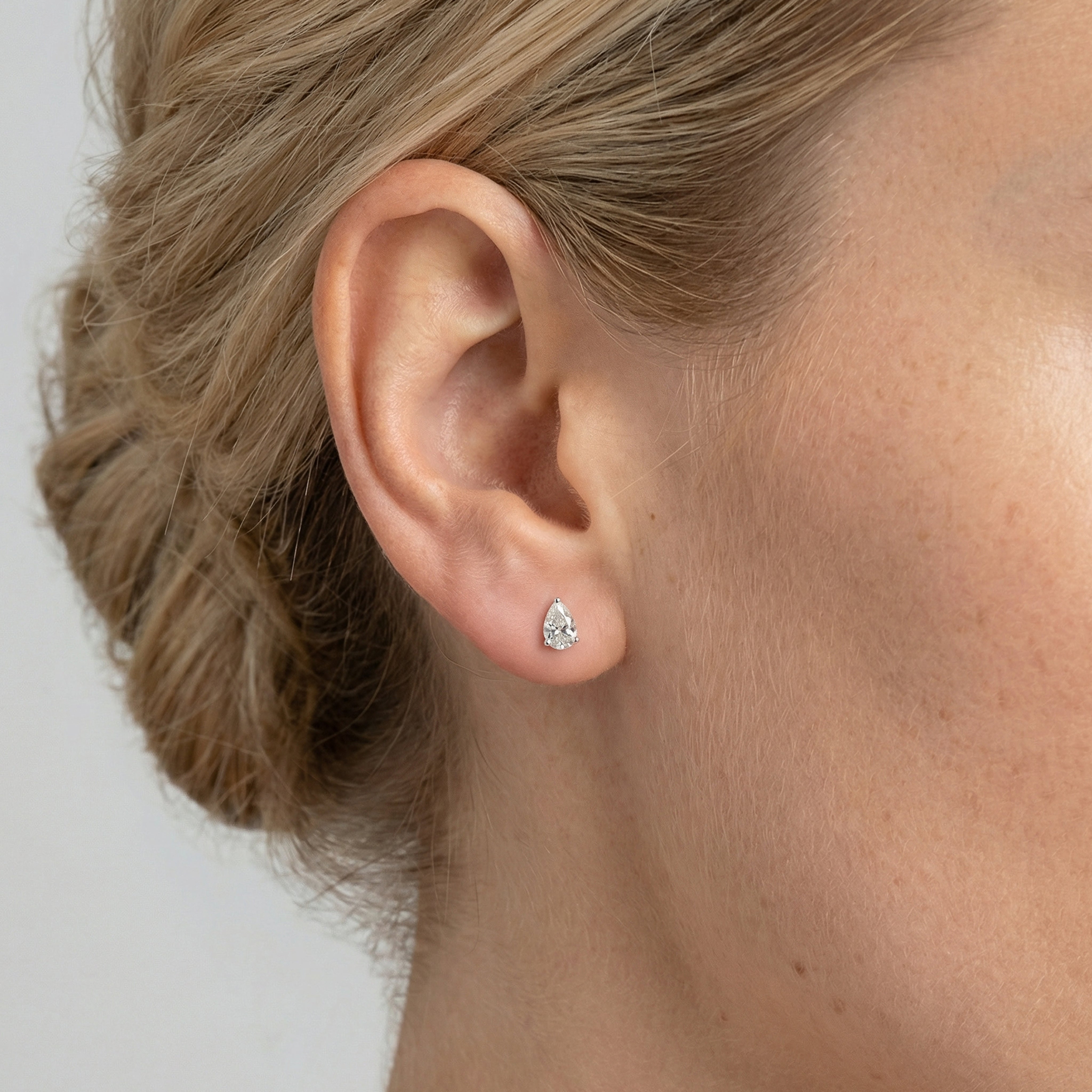 .75 carat pear lab grown diamond stud earring in 14k white gold on ear by Michael Gabriels