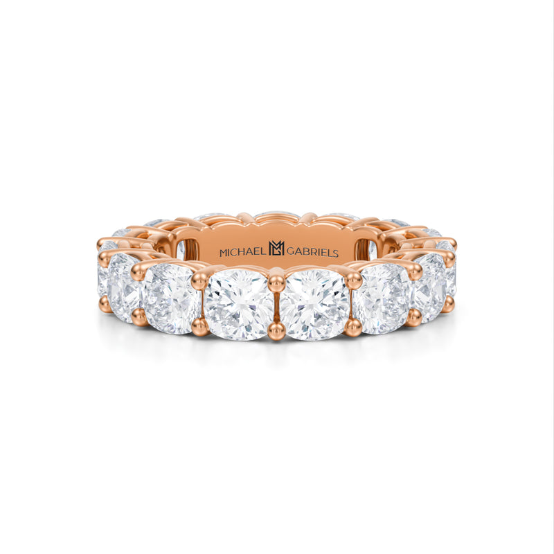 Rose gold eternity band with cushion cut lab grown diamonds.