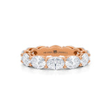 Rose gold eternity band with lab-grown diamonds in oval shape.
