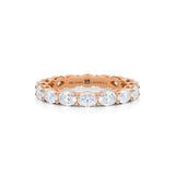 Rose gold eternity band with lab-grown diamonds in petite oval shape.