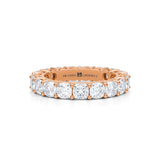 Rose gold eternity band with cushion cut lab grown diamonds.