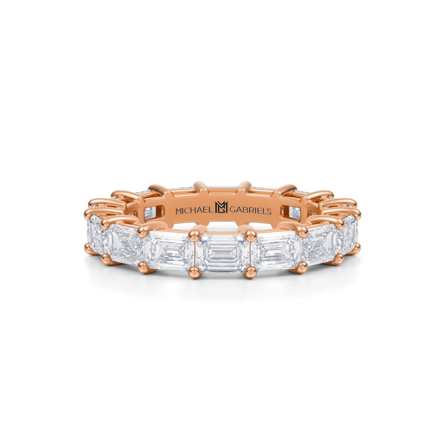 Rose gold eternity band with emerald lab-grown diamonds.