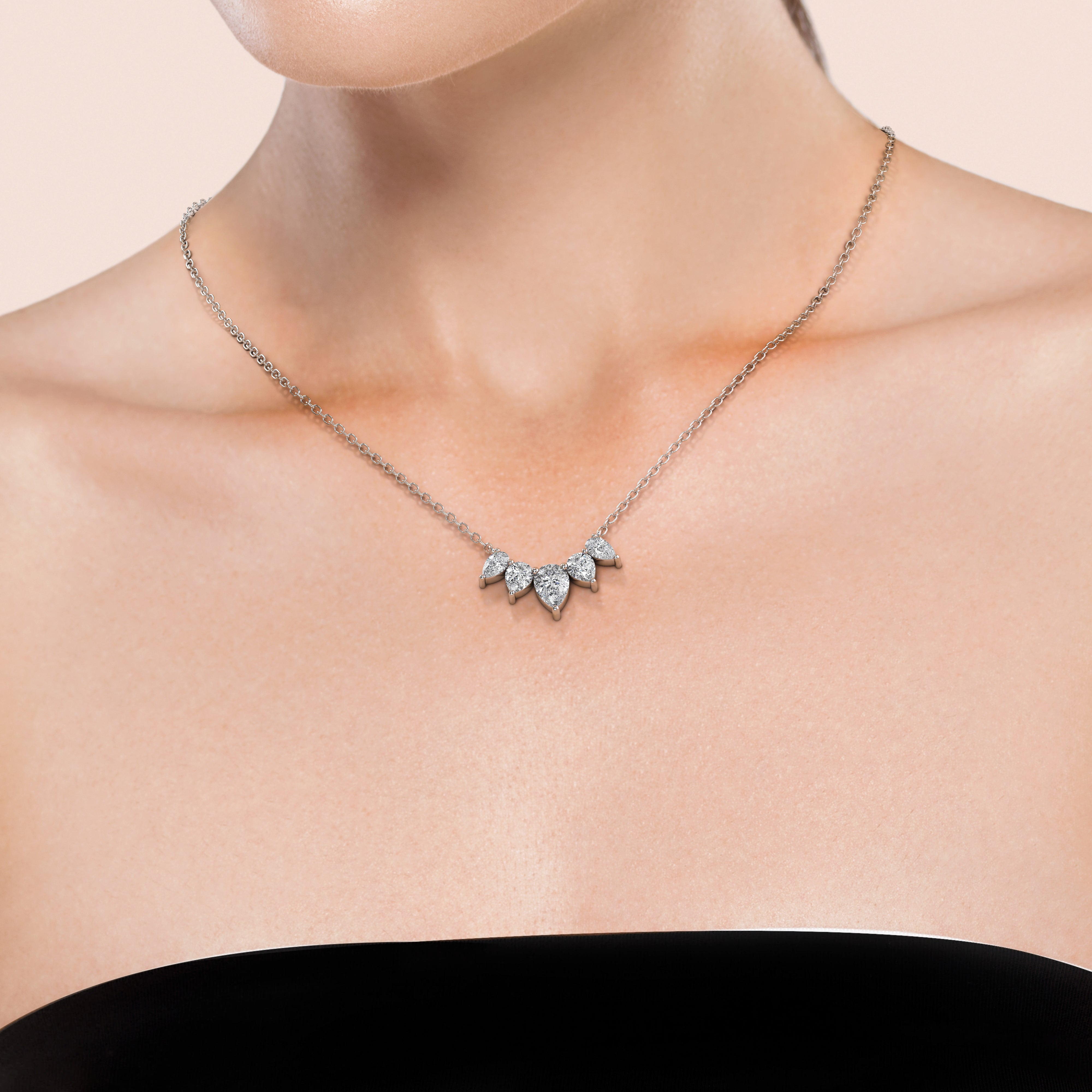 Stunning 2 TCW graduated necklace with 
lab grown 
pear cut diamonds, worn by woman