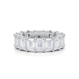 White gold eternity band with emerald lab grown diamonds.