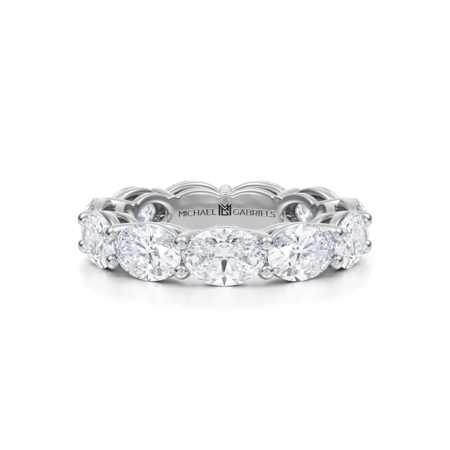 White gold eternity band with oval lab-grown diamonds.