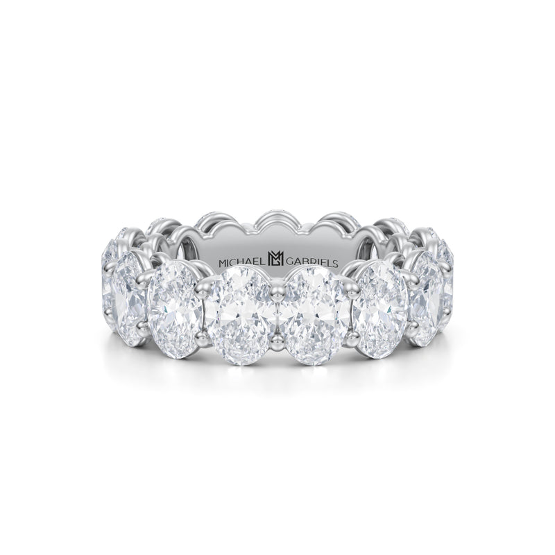 White gold eternity band with vertical oval lab-grown diamonds.