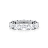 White gold eternity band with oval lab-grown diamonds.