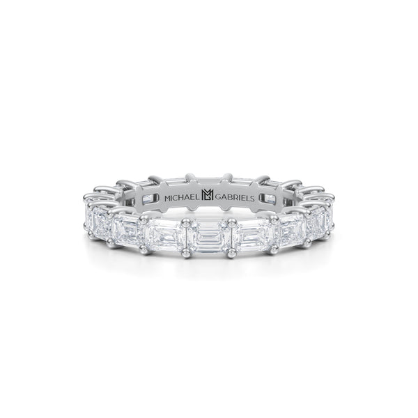Petite white gold eternity band with lab-grown emerald diamonds.