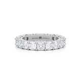 White gold eternity band with cushion cut lab grown diamonds.