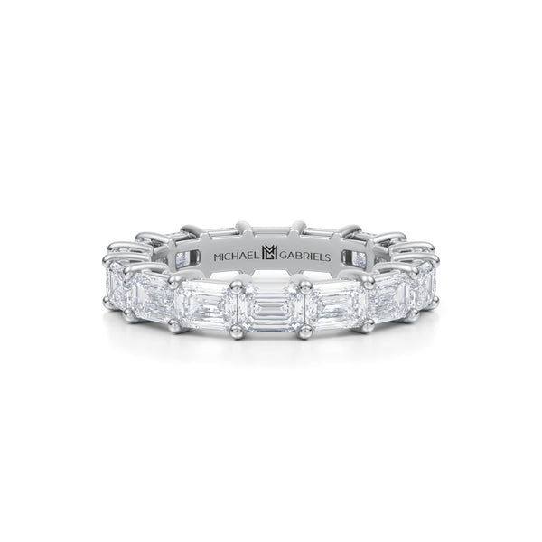 White gold eternity band with emerald lab-grown diamonds.