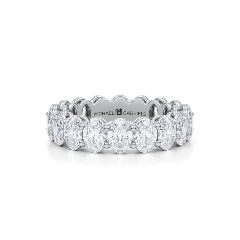 Small white gold eternity band with vertical oval lab-grown diamonds.