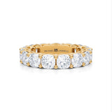 Yellow gold eternity band with cushion cut lab grown diamonds.