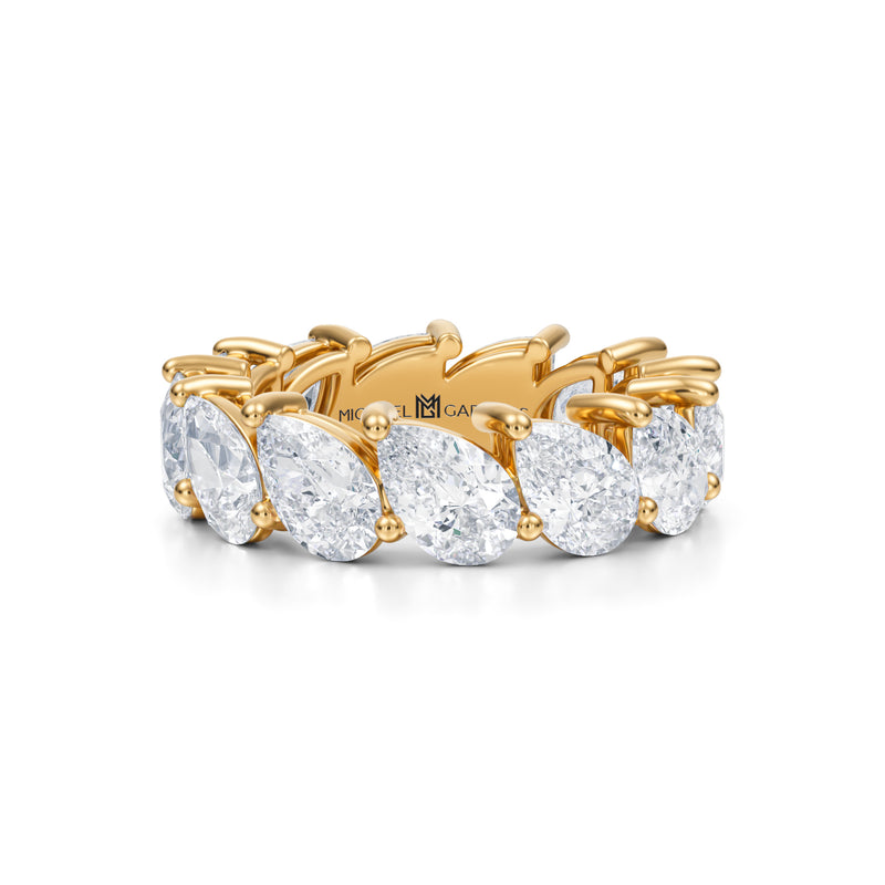 Yellow gold eternity band with slanted pear lab-grown diamonds.