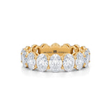 Yellow gold eternity band with lab-grown diamonds in vertical oval shape.