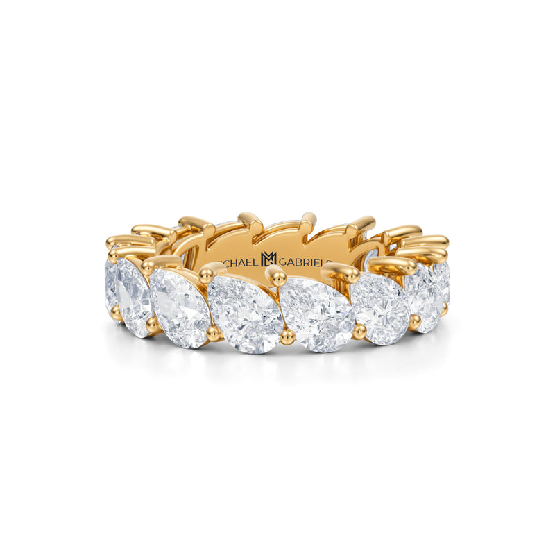 Yellow gold eternity band with slanted pear lab-grown diamonds.