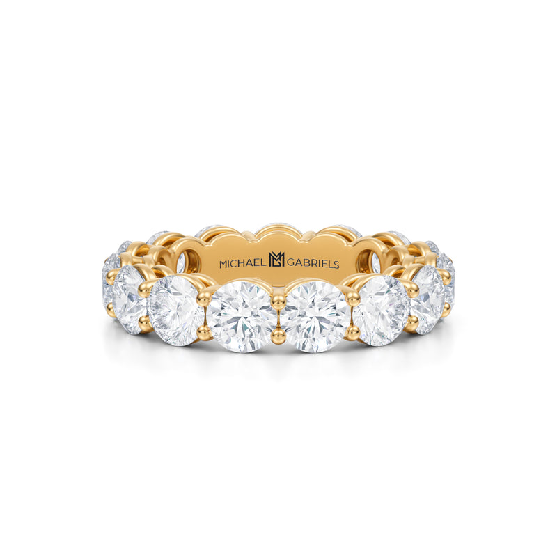 Yellow gold eternity band with lab-grown diamonds.