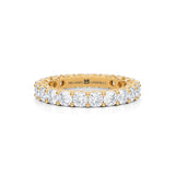 Petite yellow gold eternity band with cushion cut lab grown diamonds.