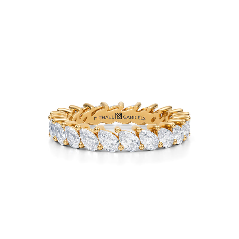 Petite yellow gold eternity band with slanted pear lab-grown diamonds.