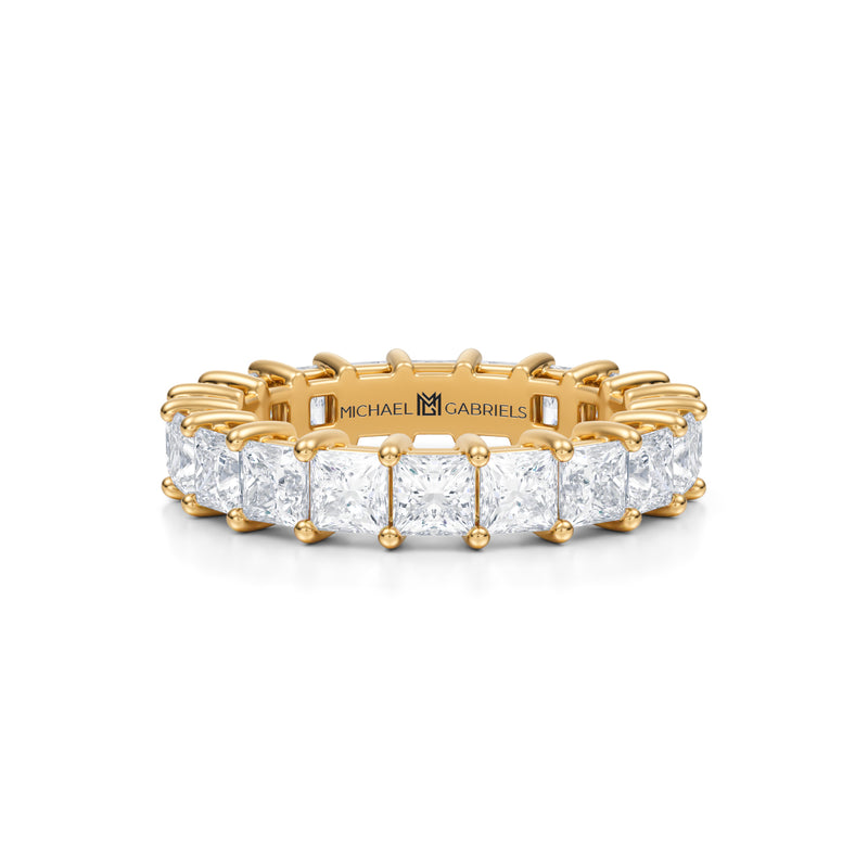 Yellow gold eternity band with princess cut lab grown diamonds.